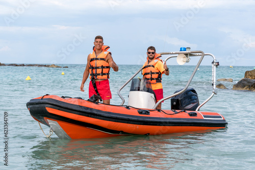Two Lifeguards working on a boat in the sea