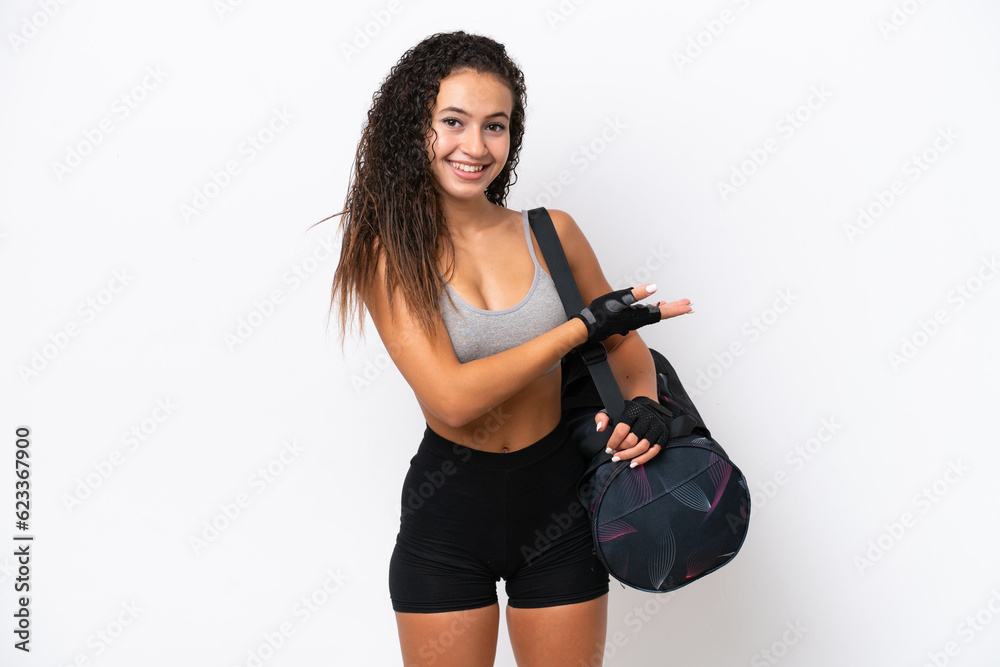 Young sport Arab woman with sport bag isolated on white background presenting an idea while looking smiling towards Young sport Arab woman with sport bag isolated on white background presenting an idea while looking smiling towards