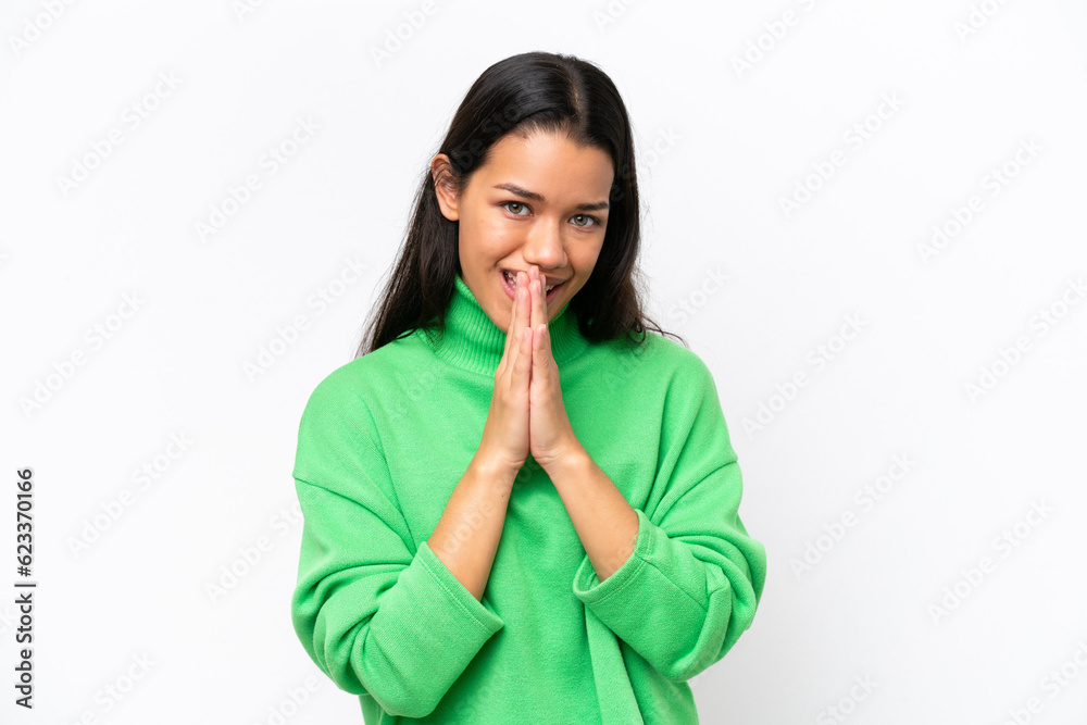 Young Colombian woman isolated on white background keeps palm together. Person asks for something Young Colombian woman isolated on white background keeps palm together. Person asks for something