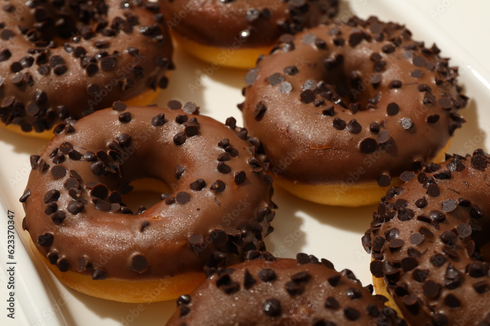 Chocolate donuts on white background, close up