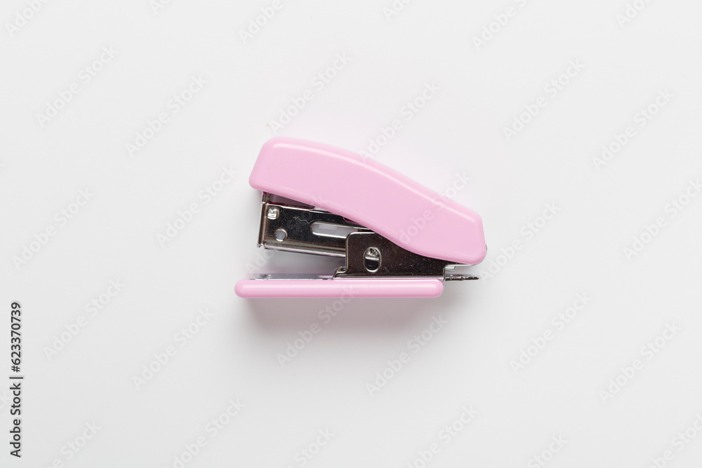 Pink stapler on color backgroung, top view Pink stapler on color backgroung, top view