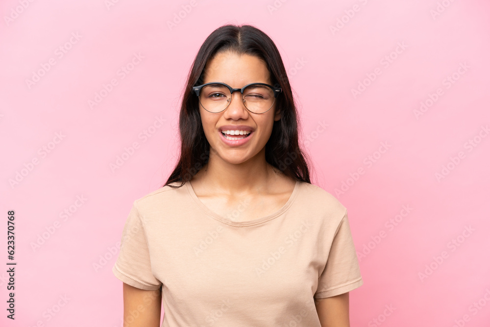Young Colombian woman isolated on pink background With glasses and happy expression Young Colombian woman isolated on pink background With glasses and happy expression