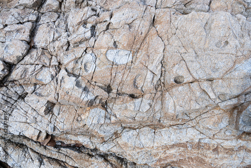 Geological structure. Rock fracture. Fracture in weathered metamorhic rock. Weathered stone background.