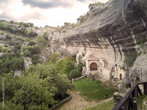 photograph of the hermitages of San Bernabé and San Tirso built in the rocks of the karstic complex of Ojo Güareña, Las Merindades, Burgos, Spain,