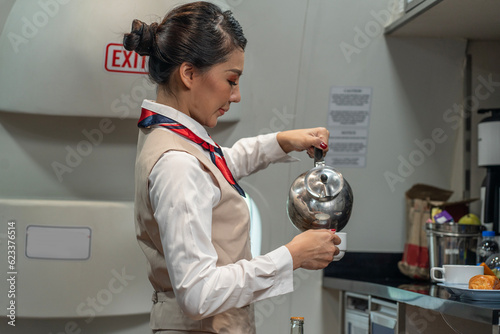 Flight attendants prepare meals, snacks and beverages during flight on the airline serving passengers on board. photo