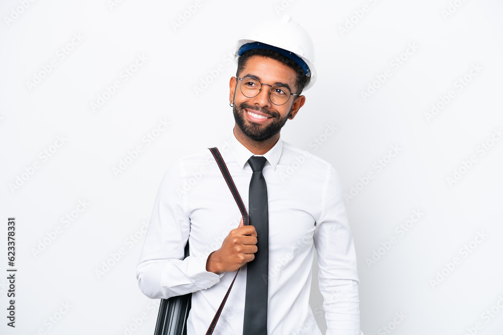 Young architect Brazilian man with helmet and holding blueprints isolated on white background thinking an idea while looking up Young architect Brazilian man with helmet and holding blueprints isolated on white background thinking an idea while looking up