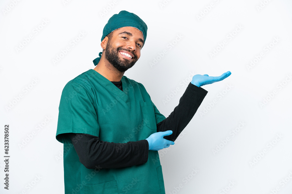 Surgeon Brazilian man in green uniform isolated on white background extending hands to the side for inviting to come Surgeon Brazilian man in green uniform isolated on white background extending hands to the side for inviting to come