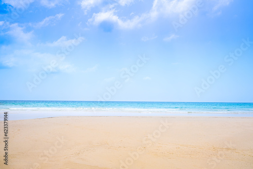 Beach sand background for summer vacation concept. Beach nature and summer seawater with sunlight light sandy beach Sparkling sea water contrast with the blue sky.