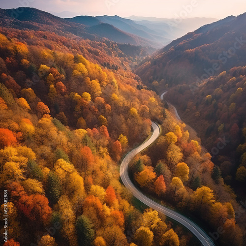 Aerial view of a mountain winding road. Beautiful mountain landscape with a roadway and a foggy horizon. © Helen-HD