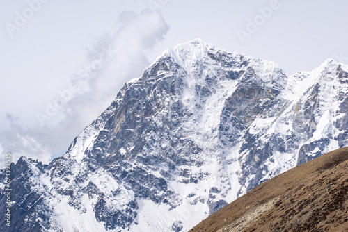 View of majestic snow covered himalayan range from everest base camp trek in nepal. Few of them are world's highest mountains. Glaciers and icy himalaya in the backdrop of a barren landscape trekking. photo