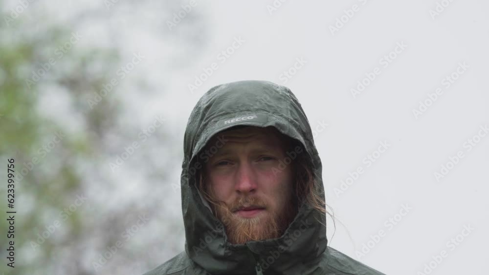 European Man In Hoodie Jacket Standing Outdoor. closeup European Man In Hoodie Jacket Standing Outdoor. closeup
