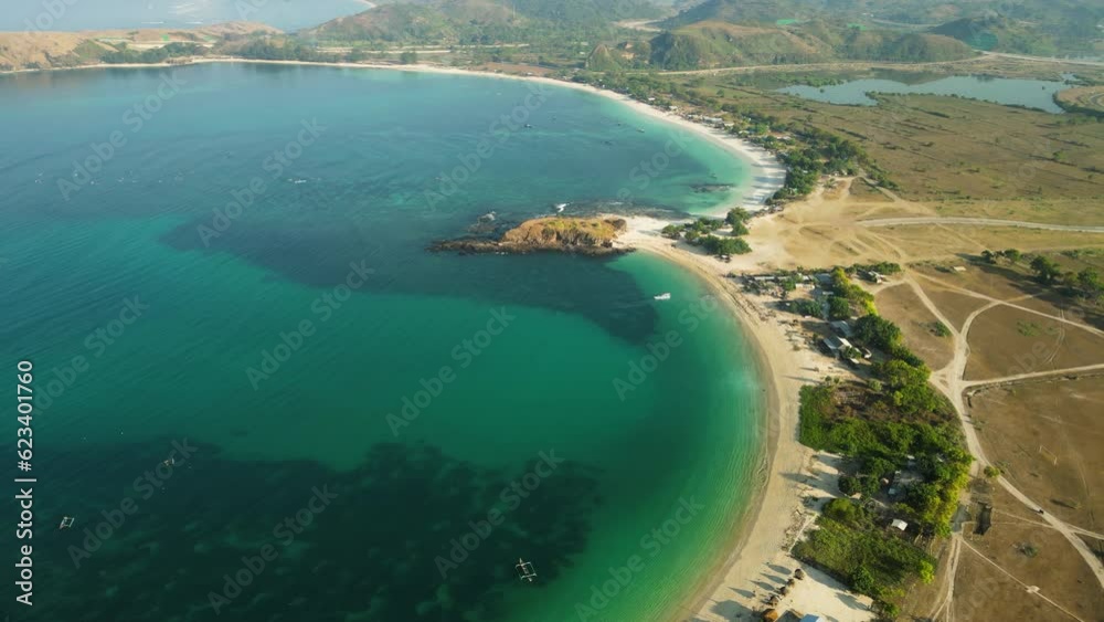 Aerial of the coastline around Tanjung Aan on Lombok Island, Indonesia. This area is known for its sandy beaches and surfing scene. Drone dolly forward shot Aerial of the coastline around Tanjung Aan on Lombok Island, Indonesia. This area is known for its sandy beaches and surfing scene. Drone dolly forward shot