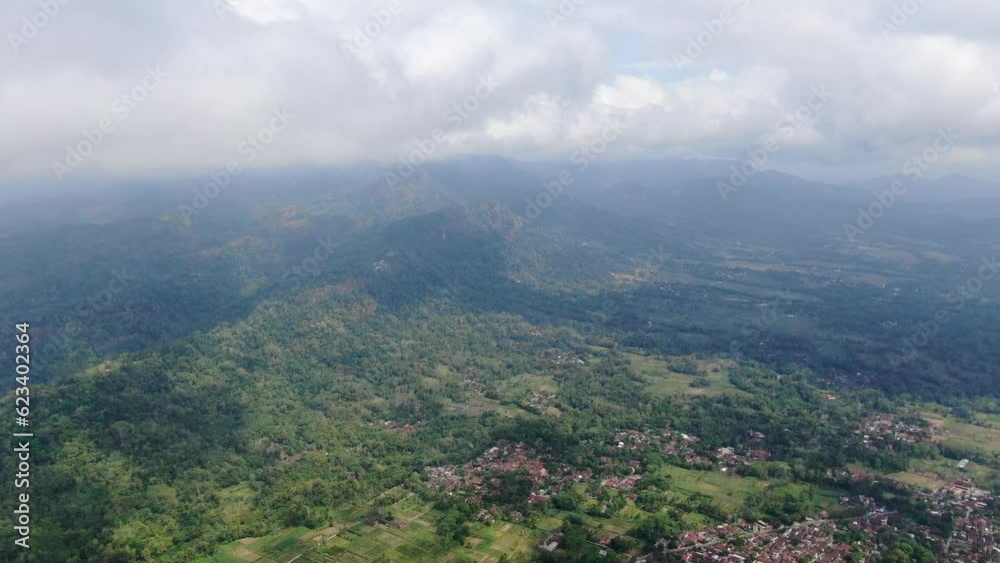 Indonesia town near hilly terrain, aerial drone view Indonesia town near hilly terrain, aerial drone view