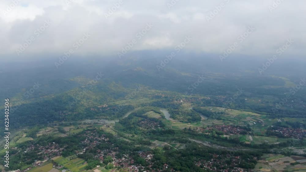Vast terrain with fields, forests and villages in Indonesia, aerial drone view Vast terrain with fields, forests and villages in Indonesia, aerial drone view