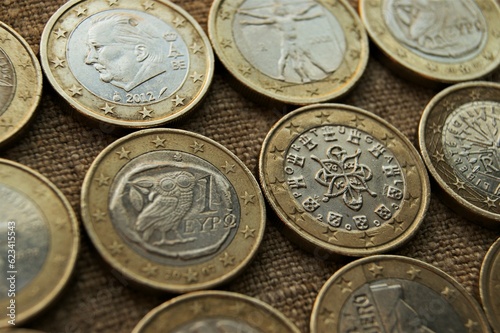 1 euro coins on natural linen fabric. Bimetallic European coins obverse.