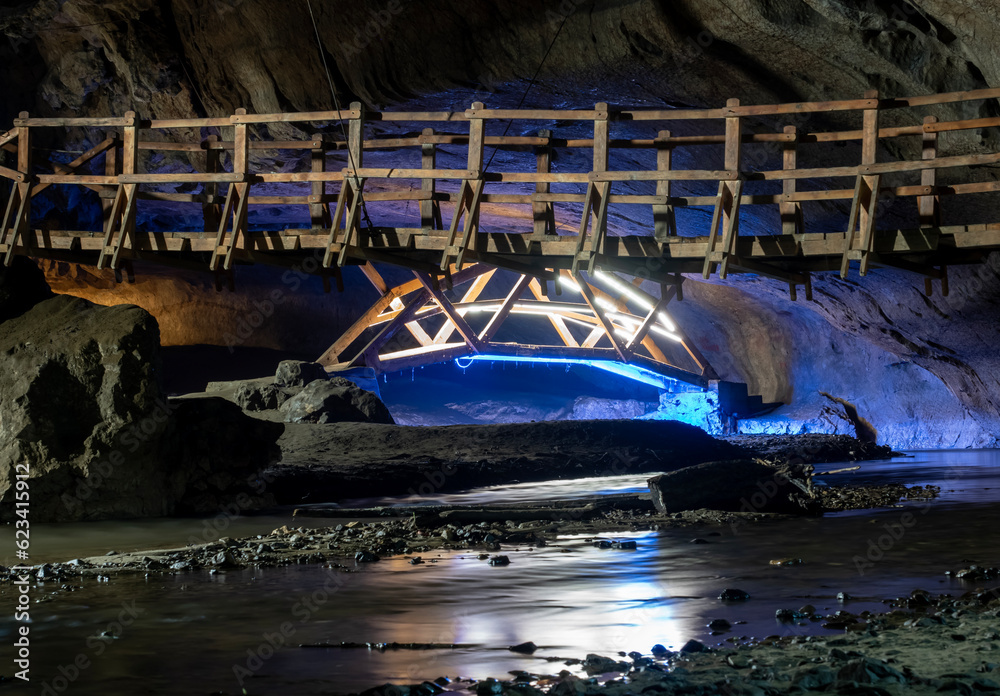 Bridge in Bolii cave ( Pestera Bolii ), near Petrosani city, Hunedoara county, Romania. The cave is artificially illuminated and is open to visitors.