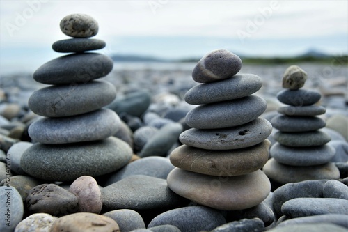 Three Zen towers on a stony beach. Towers made of pebbles.