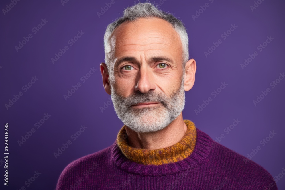 Obraz premium Close-up portrait photography of a glad mature man wearing a cozy sweater against a vibrant purple background. With generative AI technology