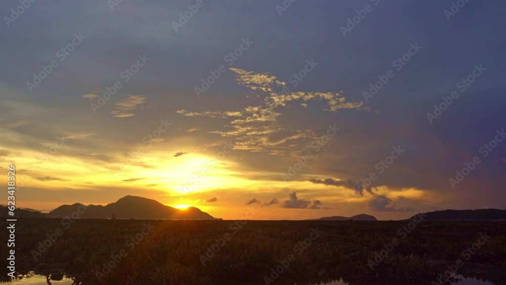 .clouds moving in yellow sky in sunrise moving slowly above islands at Rawai beach Phuket. Nature video High quality footage. .yellow sunrise above coral reef. Scene of Colorful sky background.. .clouds moving in yellow sky in sunrise moving slowly above islands at Rawai beach Phuket. Nature video High quality footage. .yellow sunrise above coral reef. Scene of Colorful sky background..