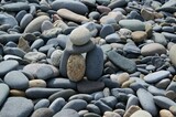 The tower is made of various pebbles on a stony beach. High quality photo