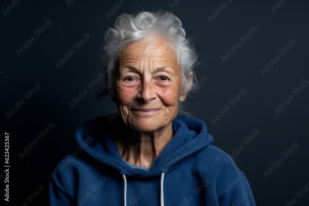 Medium shot portrait photography of a satisfied old woman wearing a cozy zip-up hoodie against a navy blue background. With generative AI technology Medium shot portrait photography of a satisfied old woman wearing a cozy zip-up hoodie against a navy blue background. With generative AI technology