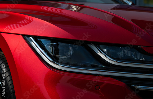 Headlight of new modern red car © Antonio