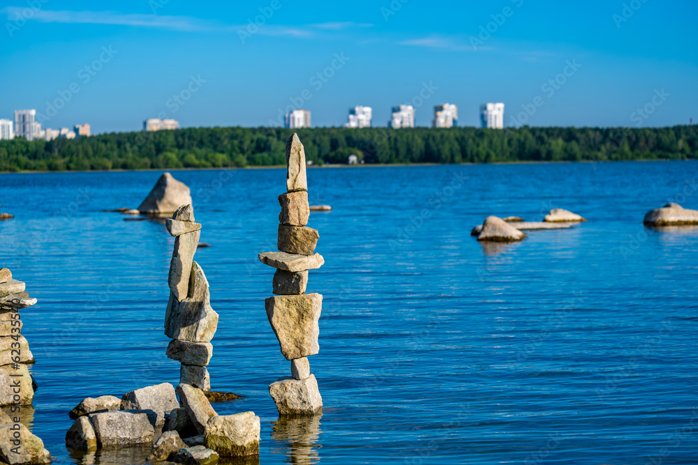 Pyramids of stones in the water of the lake near the shore. Pyramids of stones in the water of the lake near the shore.