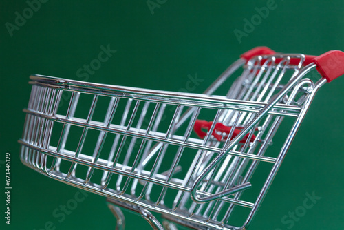 shopping trolley on the green background