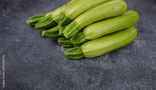 Fresh zucchini, green vegetables on local farmer market freshly harvested courgette, summer squash. raw in salads or cooked, extremely versatile, tender and easy to include in many light dishes