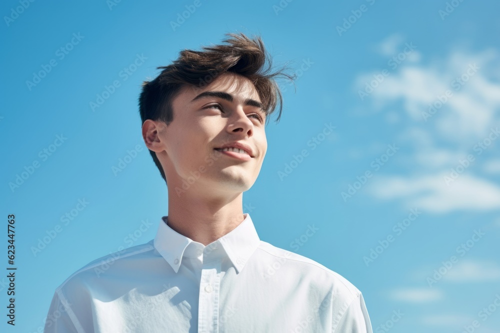 Close-up portrait photography of a satisfied boy in his 20s wearing an elegant long-sleeve shirt against a sky-blue background. With generative AI technology Close-up portrait photography of a satisfied boy in his 20s wearing an elegant long-sleeve shirt against a sky-blue background. With generative AI technology