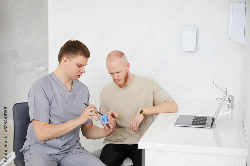 Obraz premium Dental care is simple. Young man on a dentist visit at the local dental clinic