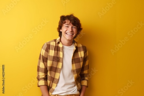 Wallpaper Mural Medium shot portrait photography of a happy boy in his 20s wearing a comfortable pair of jeggings against a yellow background. With generative AI technology Torontodigital.ca