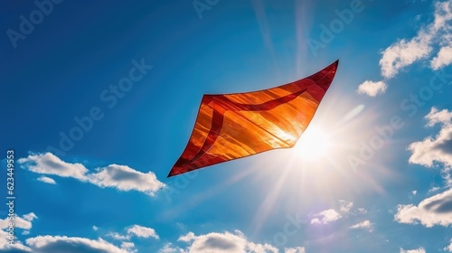 Kite flying in the blue sky between clouds