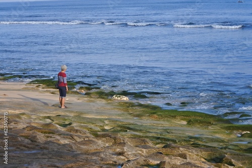 A woman standing at Tegalwangi beach. photo