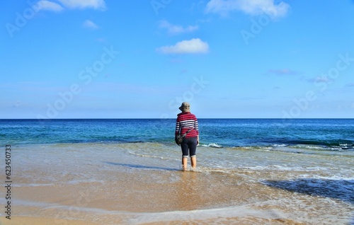 A woman standing at Tegalwangi beach. photo