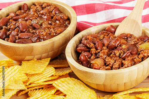 A wooden bowl of delicious Chili with Cheddar Cheese