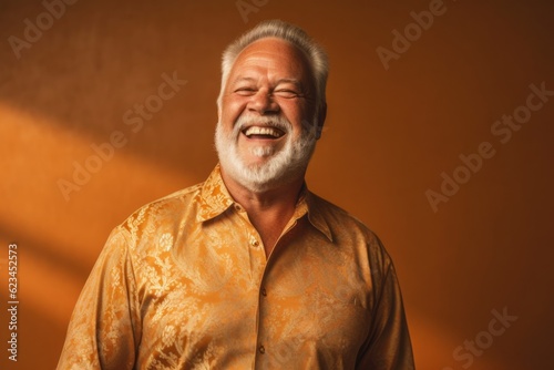 Medium shot portrait photography of a joyful mature man wearing a classy button-up shirt against a gold background. With generative AI technology