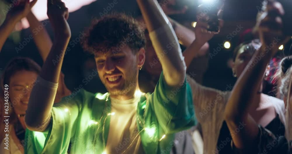 Dancing, event and people celebrate at a festival or concert together at a outdoor social with music, brights and drinks. Night, excited and young friends at a birthday gathering or reunion vacation