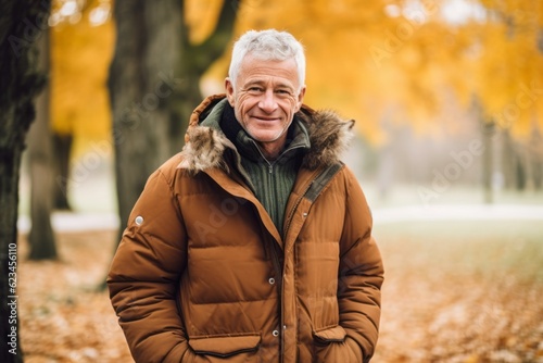 Environmental portrait photography of a glad mature man wearing a warm parka against an autumn foliage background. With generative AI technology
