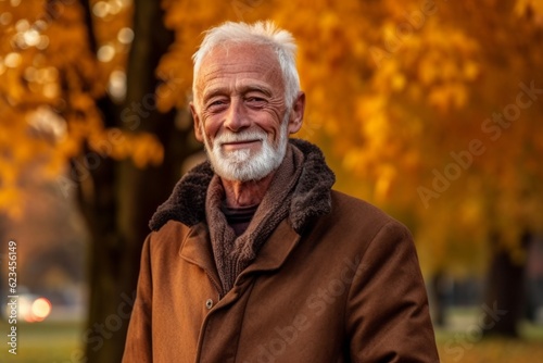 Medium shot portrait photography of a grinning old man wearing a cozy winter coat against an autumn foliage background. With generative AI technology