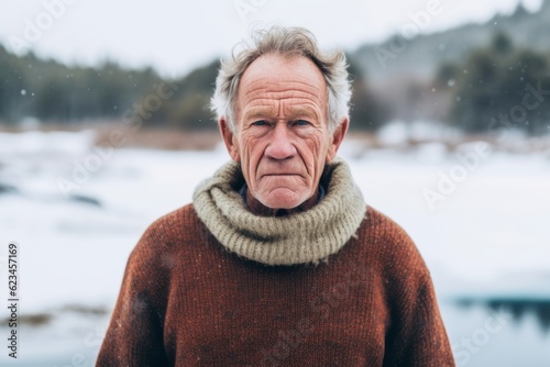 Environmental portrait photography of a tender old man wearing a cozy sweater against a snowy landscape background. With generative AI technology