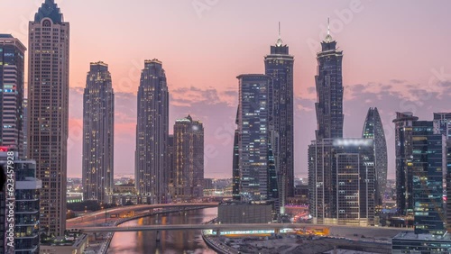 Wallpaper Mural Cityscape with skyscrapers of Dubai Business Bay and water canal aerial day to night transition timelapse. Modern skyline with residential and office towers on waterfront after sunset Torontodigital.ca