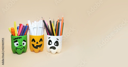 The art of handmade recycling from plastic bottle. Halloween craft ideas of container for pencils. Crafts for the children's room photo