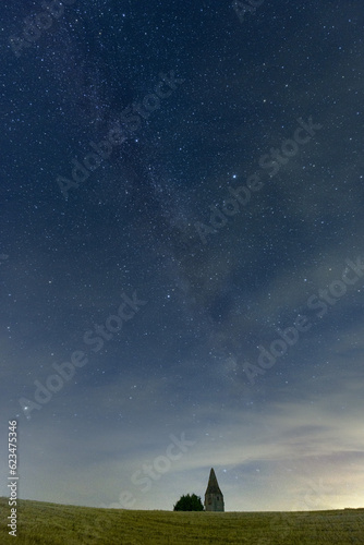 Middle european nightscape near an ancient watchtower. Milkyway, nightsky and stars photo