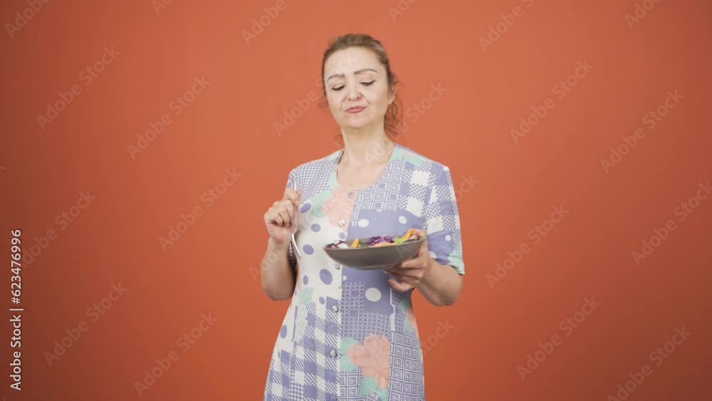 A person who diets and eats healthily. She eats salad and dances.