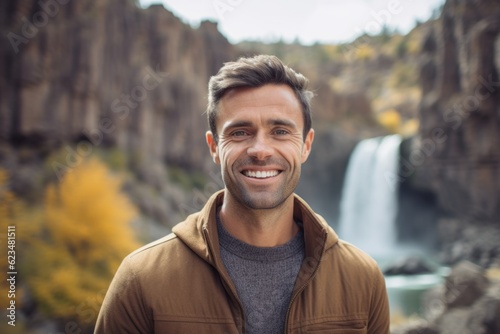 Tela Headshot portrait photography of a satisfied boy in his 30s wearing a classic turtleneck sweater against a majestic waterfall background