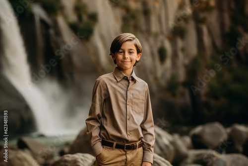 Casual fashion portrait photography of a joyful mature boy wearing an elegant long-sleeve shirt against a majestic waterfall background. With generative AI technology