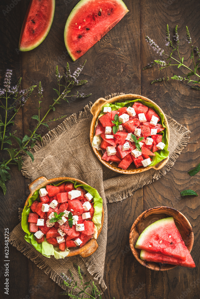 Fresh watermelon salad with feta cheese and mint on rustic wooden background