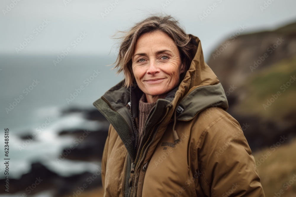 Studio portrait photography of a happy mature girl wearing a durable parka against a dramatic coastal cliff background. With generative AI technology Studio portrait photography of a happy mature girl wearing a durable parka against a dramatic coastal cliff background. With generative AI technology