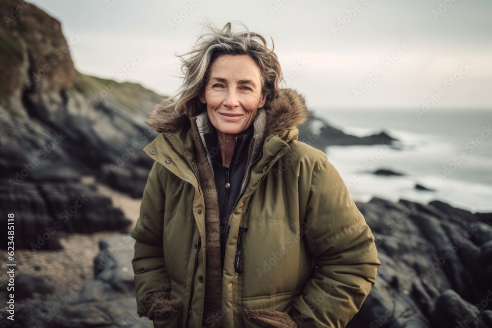 Studio portrait photography of a happy mature girl wearing a durable parka against a dramatic coastal cliff background. With generative AI technology Studio portrait photography of a happy mature girl wearing a durable parka against a dramatic coastal cliff background. With generative AI technology